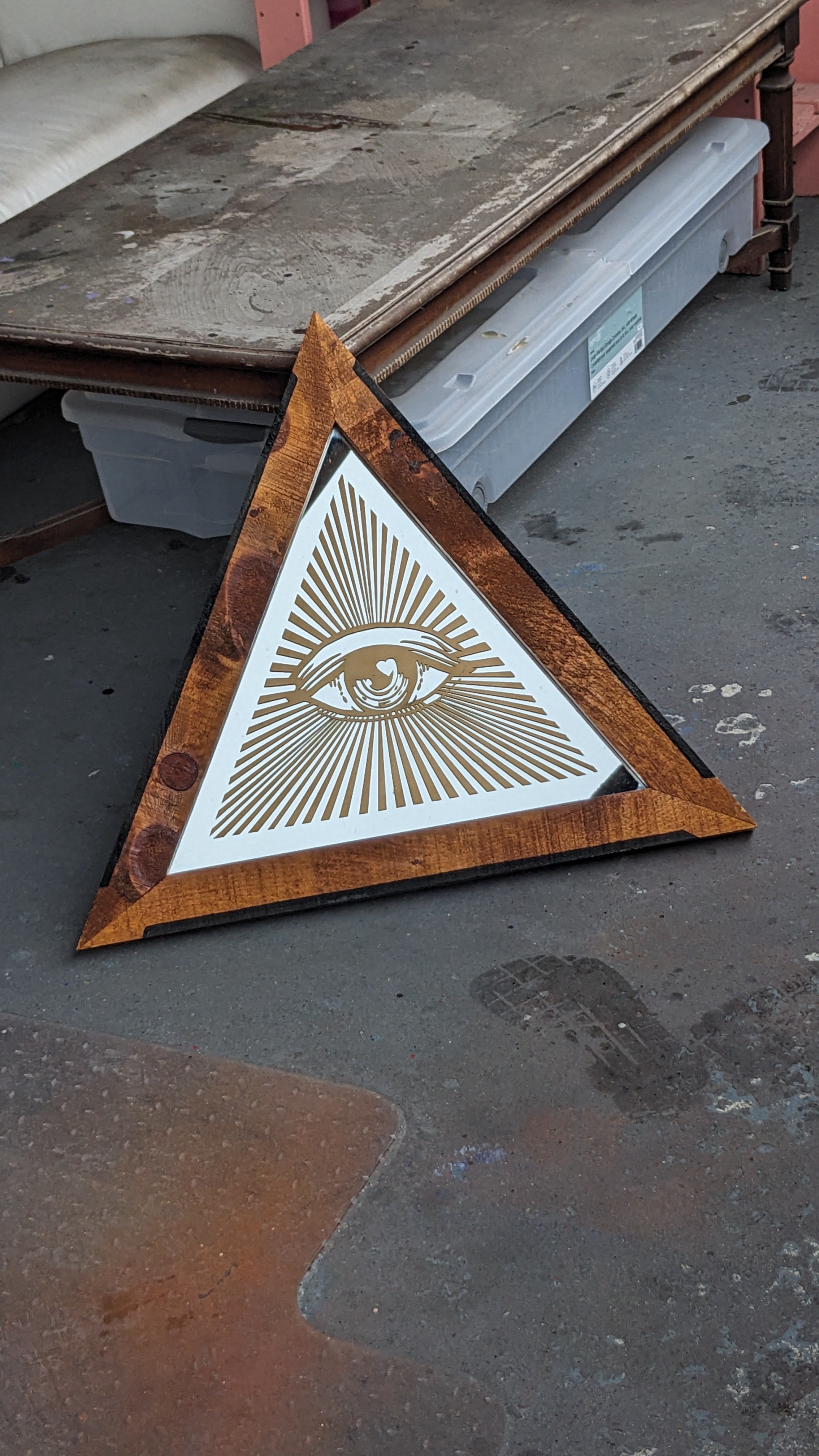 Wooden framed triangular mirror with spray painted design. 24’ wide at base, 20’ tall at centre 