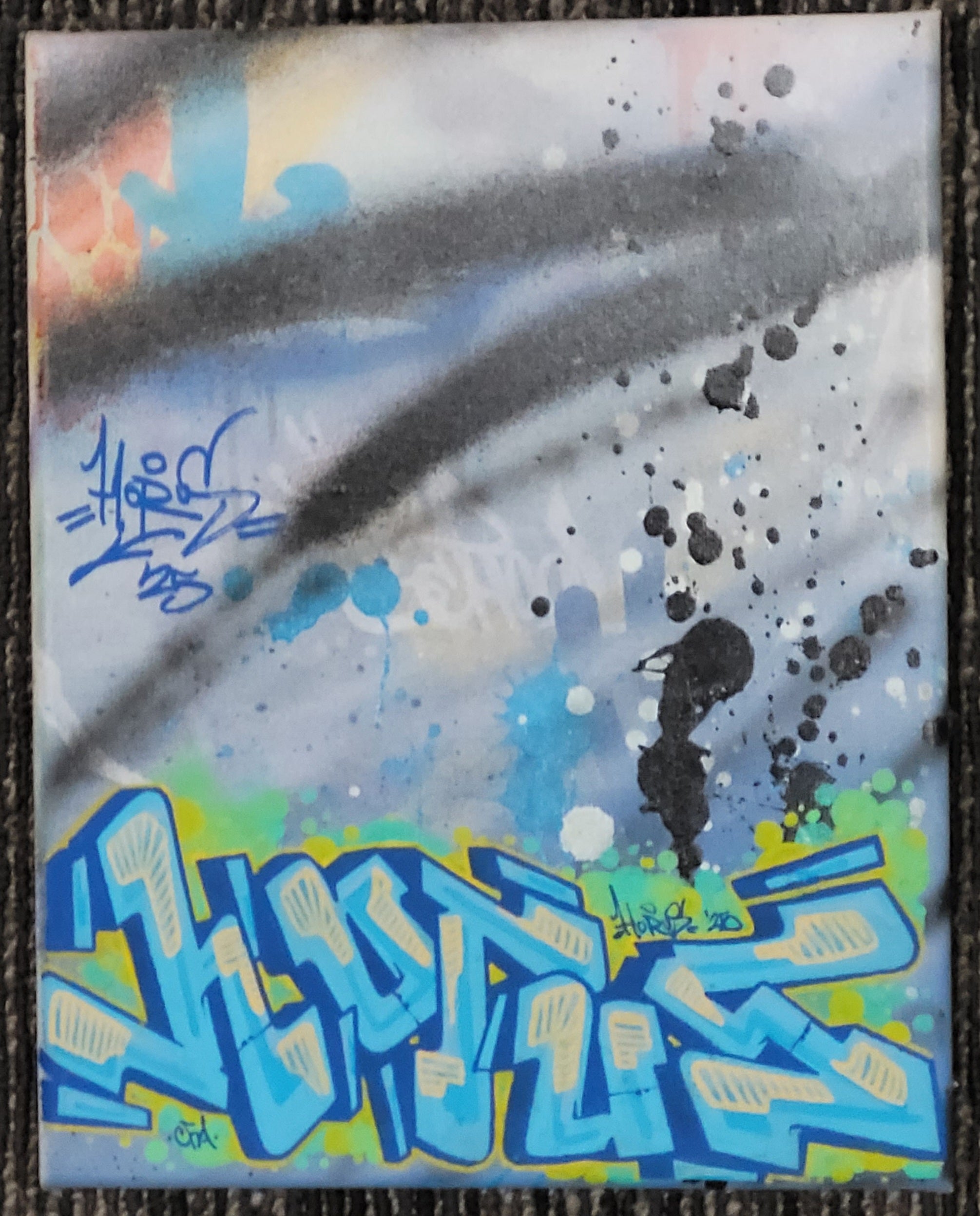 Image 3 (Blue Canvas): "An 8x10 inch vertical graffiti art canvas by HORUS, titled 'Blueberry Aerie.' The top half is a cool light blue and grey background with abstract black spray paint streaks and white speckles, and blue handwritten tags. The bottom half showcases sharp, angular graffiti letters in bright blue with light blue and white highlights, spelling 'HORUS' in a throw-up style. The canvas has a dark border."