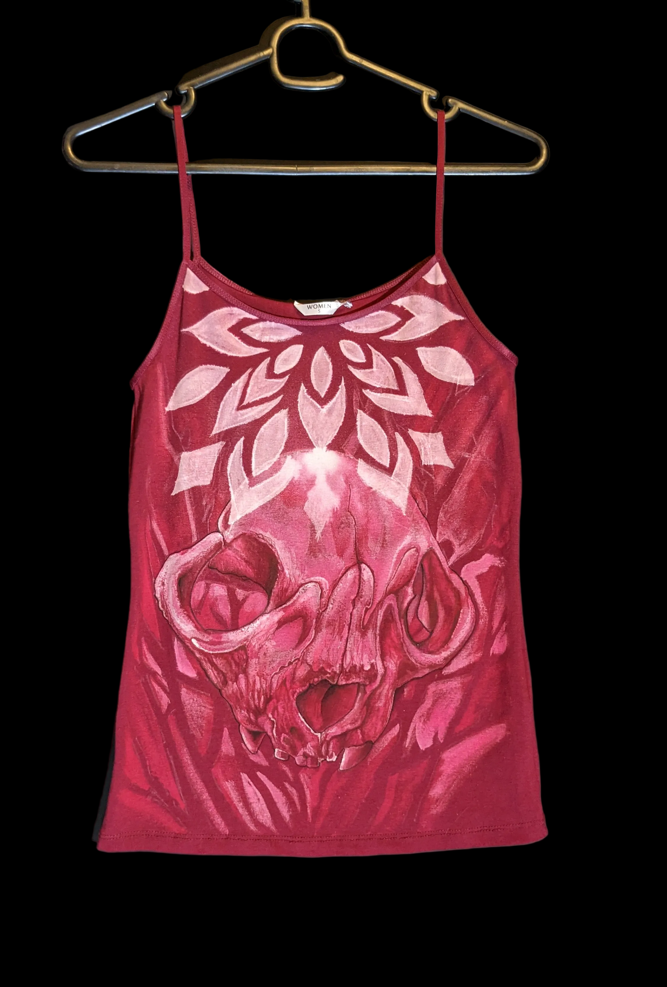 Red tank top with white floral design on a black background