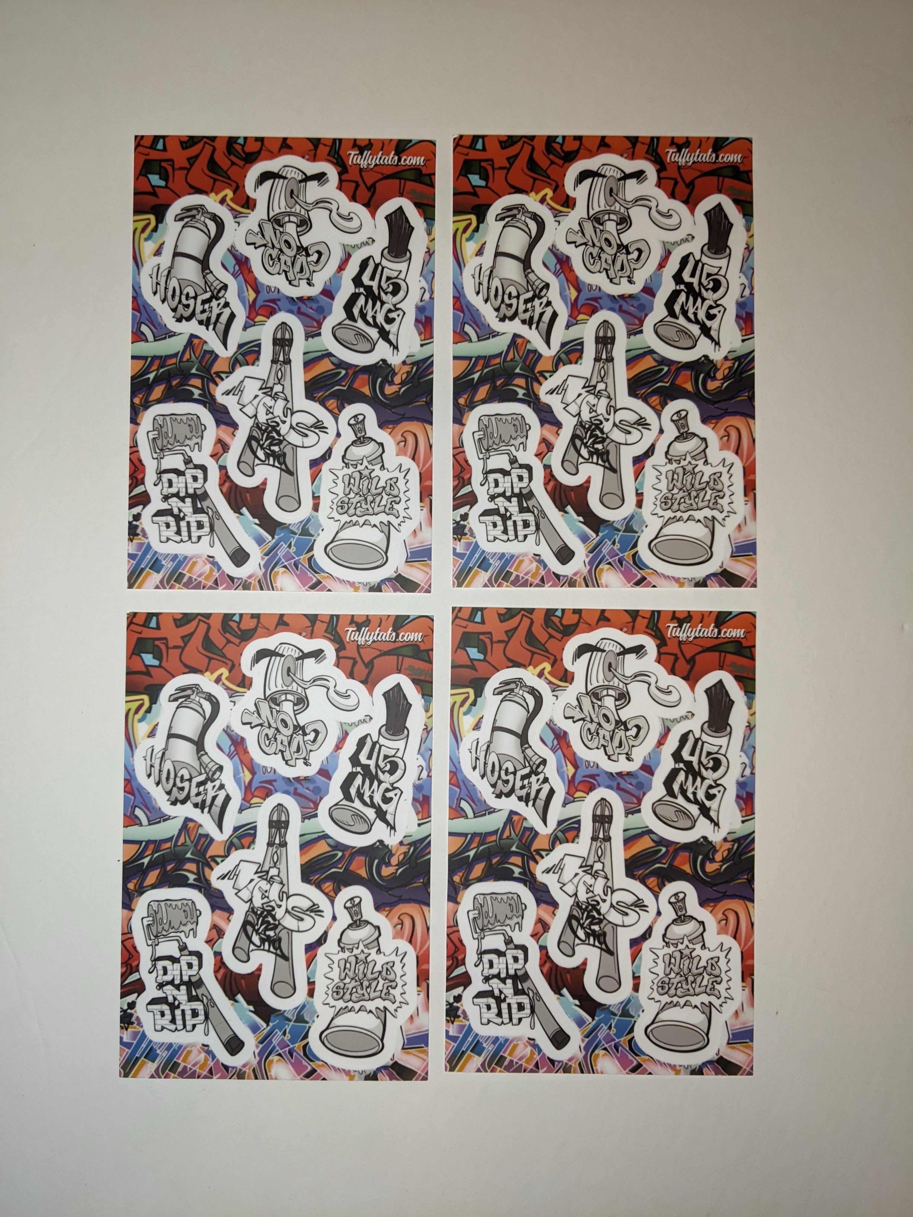 A set of six graffiti-themed stickers by Horus, featuring stylized illustrations of spray cans, a paint roller, and a fire extinguisher with urban slang tags like "No Cap" and "Wild Style."